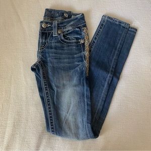 Miss me signature skinny jeans. Cross design on back pockets.